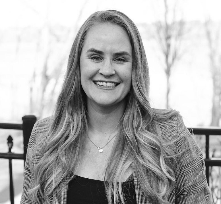 black and white image of Jade Erickson, LICSW smiling at the camera